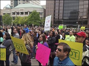 In this May, 2017 photo, hundreds of supporters of Ohio's largest online charter school, the Electronic Classroom of Tomorrow or ECOT, participate in a rally outside the Statehouse in Columbus.