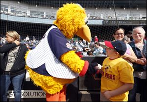 Nick Pfaff  10, of Navarre Elementary School, gets a baseball from Muddy the Mud Hen before the Mud Hens' game against the Charlotte Knights at Fifth Third Field Wednesday. Toledo will host another School Celebration Day game Thursday.