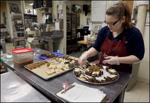 Noelle Gleason creates a pastry tray at Michael's Bakery. Martin Luther King Bridge will be closed for 45 days, impacting business on Main St. in Toledo.
