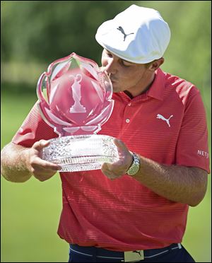 Bryson DeChambeau kisses the trophy after winning the Memorial Tournament in Dublin, Ohio.
