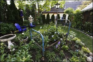 A bed frame is featured in Tracy Tersigni's garden at her home in Old Orchard.