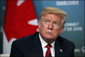 President Donald Trump listens to a question during the G-7 summit in Charlevoix, Canada.