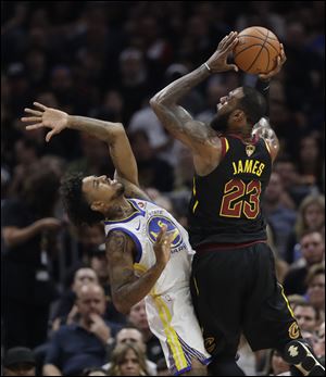 Cleveland Cavaliers forward LeBron James shoots over Golden State Warriors guard Nick Young on Friday's Game 4 in Cleveland.