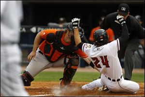 Toledo Mud Hens' Pete Kozma slides into home plate during Saturday's game against the Norfolk Tides at Fifth Third Field. Kozma was called out on the play.