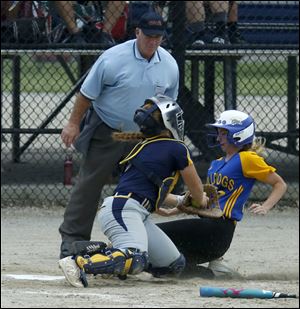 Whiteford catcher Milly Lott misses the tag on Centreville's Addy Ward during the 2018 MHSAA Quarterfinal at Bailey Park Complex in Battle Creek, Mich.