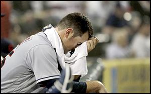 Cleveland starting pitcher Adam Plutko rests on the dugout rail after being pulled in the fifth inning.