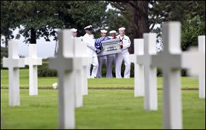 U.S. Navy personnel carry the casket of a WWII U.S. Navy sailor during a reburial service at the Normandy American Cemetery, Colleville-sur-Mer, France, in June. As part of a tour of World War II sites, a Springfield student and teacher had the opportunity to eulogize a soldier from Toledo buried at the cemetery. 