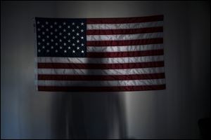 A veteran of the Second Battalion, Seventh Marine Regiment casts a shadow in his apartment in Mesa, Ariz., in 2015.