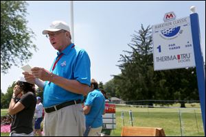 Volunteer Don Czarcinski calls out the names of the next golfing group to tee off on No. 1 in the first round of the LPGA Marathon Classic on Thursday at Highland Meadows. Czarcinski has been present for every Toledo tournament except one.