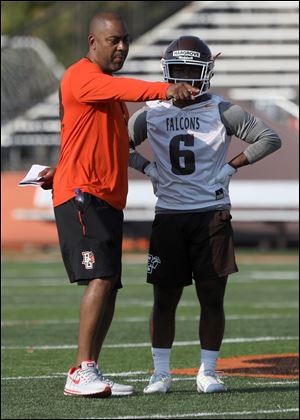 Bowling Green head coach Mike Jinks gives instruction to Ra'Veion Hargrove during opening day of practice Friday.