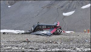 The photo provided by Police Graubuenden shows the wreckage of the old-time propeller plane Ju 52  after it went down went down Saturday on the Piz Segnas mountain above the Swiss Alpine resort of Flims, striking the mountain's western flank.