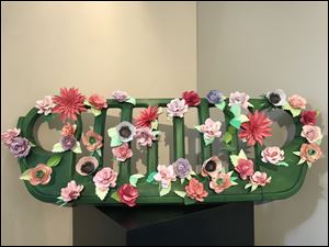 The Young Artists at Work group Team ARTillery -- Maggie Marx, Taylor Hill, Trinidad Martinez, Jada Russell, Linda Galloway, Damondjae Johnson, and Ethan Warren -- created a green floral grill. 