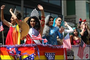 Drag queens wave to the crowd from a float during the Toledo Pride Parade and Festival in downtown Toledo last year.