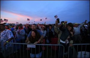 Fans watch as the sun sets and Toby Keith performs during the Bash On The Bay country music festival at Put-in-Bay, Ohio, on Thursday, August 31, 2017. Keith headlined the event.