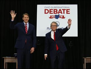 Democratic gubernatorial candidate Richard Cordray, left, and Ohio Attorney General and Republican gubernatorial candidate Mike DeWine wave to the crowd before a recent debate.